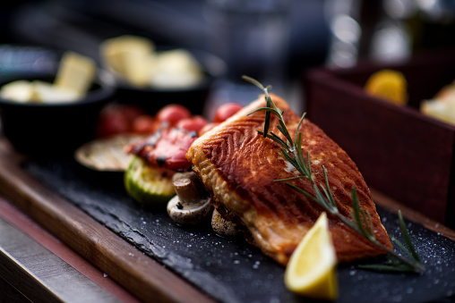 Low carb meal with salmon filet and side salad